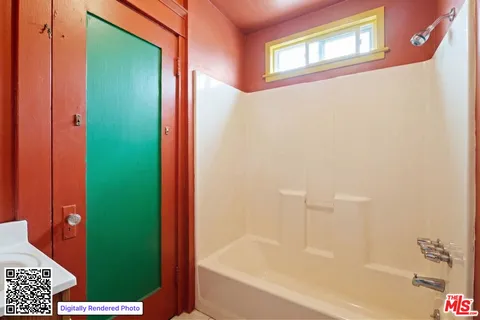 a bathroom with a bathtub and a shower