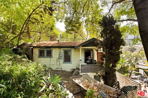front view of a house with a tree