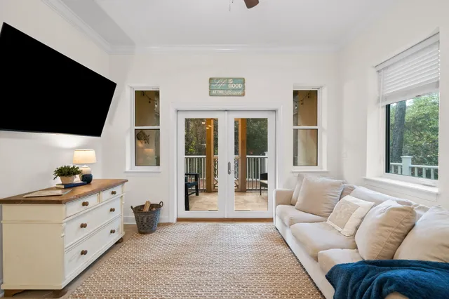 a view of a hallway with wooden floor and a bathroom