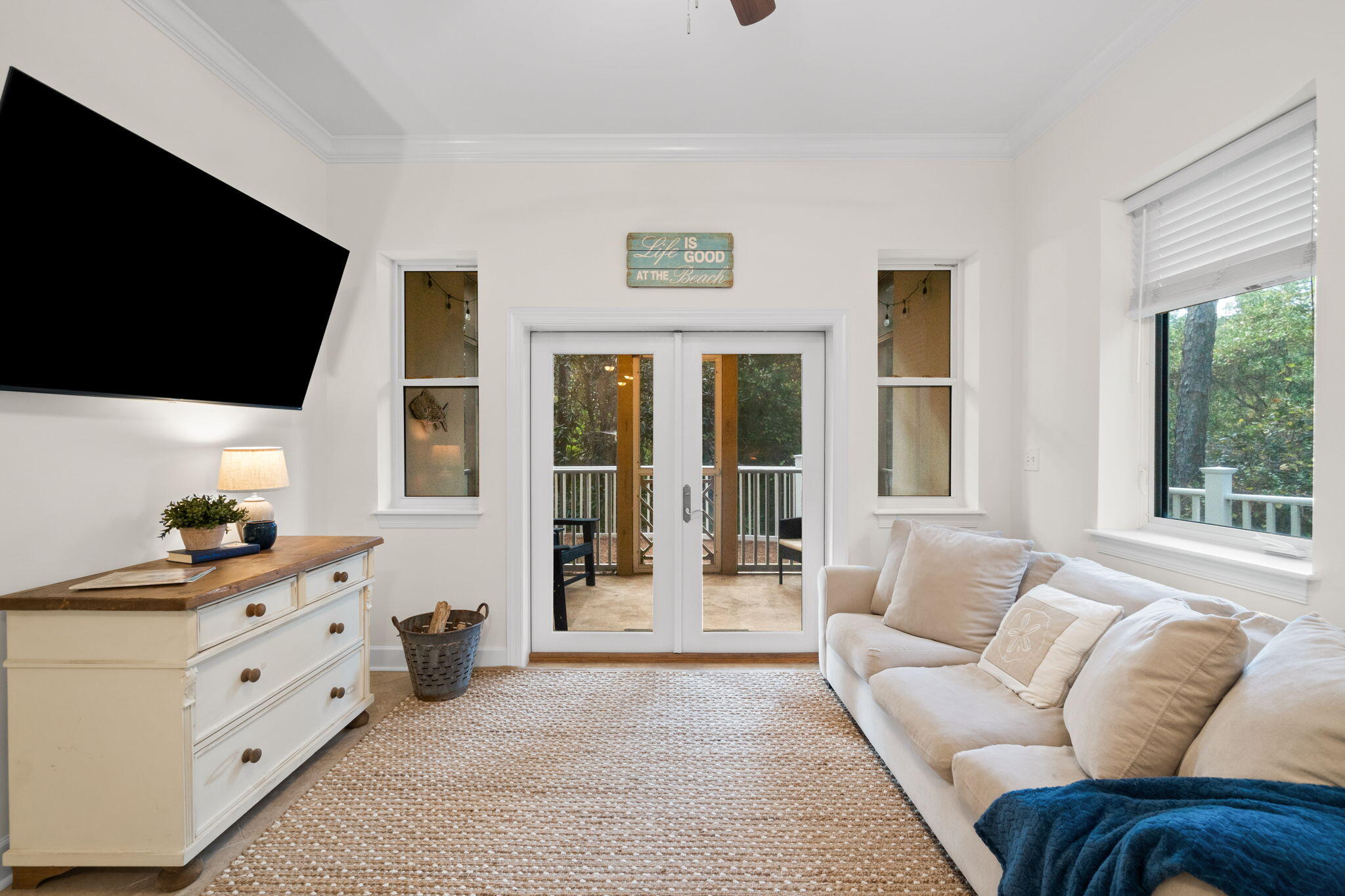 231 Somerset Bridge Road, Unit 2101 Santa Rosa Beach, FL 32459 - Photo 14 of 48 a living room with furniture a flat screen tv and a floor to ceiling window