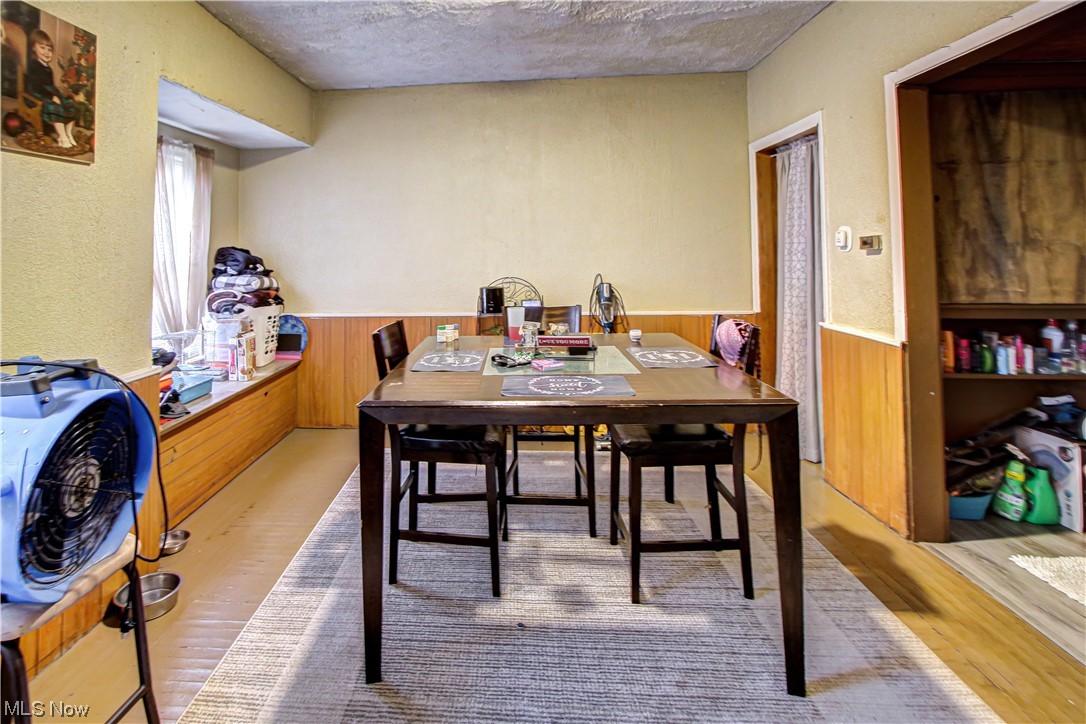 3816 Riverside Avenue Cleveland, OH 44109 - Photo 23 of 35 Dining room featuring light hardwood flooring and a textured ceiling
