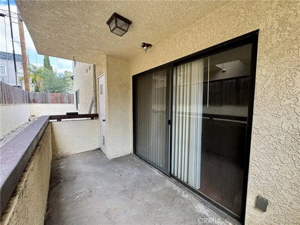 a view of a kitchen with a refrigerator and a sink