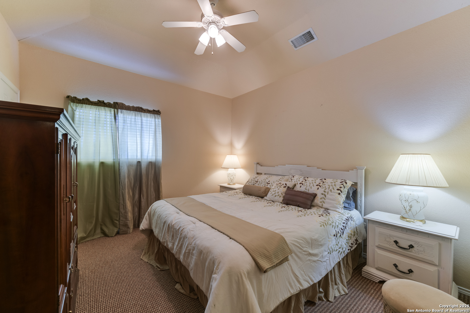 4614 County Road 5232 D'Hanis, TX 78850 - Photo 34 of 40 a bedroom with a large bed and a chandelier