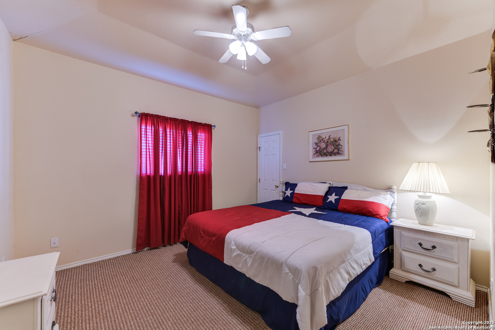 4614 County Road 5232 D'Hanis, TX 78850 - Photo 36 of 40 a bedroom with a large bed and a chandelier