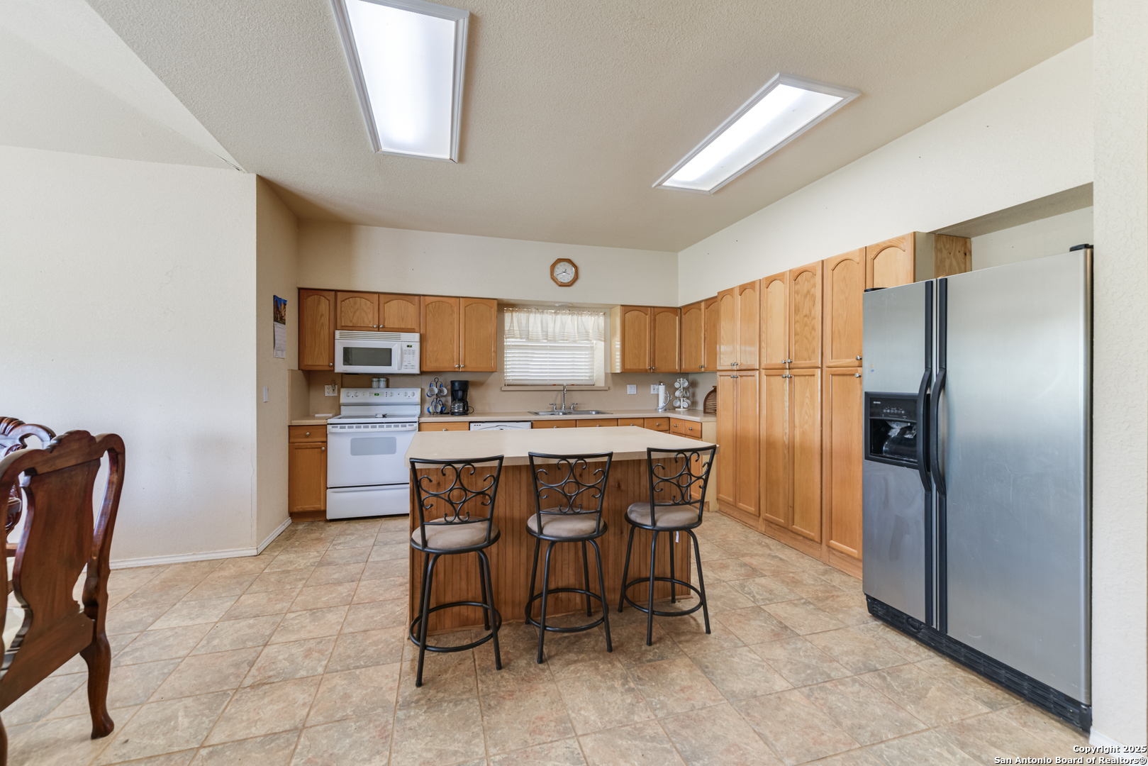 4614 County Road 5232 D'Hanis, TX 78850 - Photo 37 of 40 a kitchen with stainless steel appliances a refrigerator a table chairs and a refrigerator