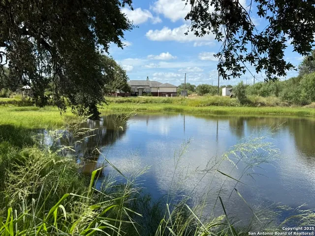 a view of a lake with houses in the back