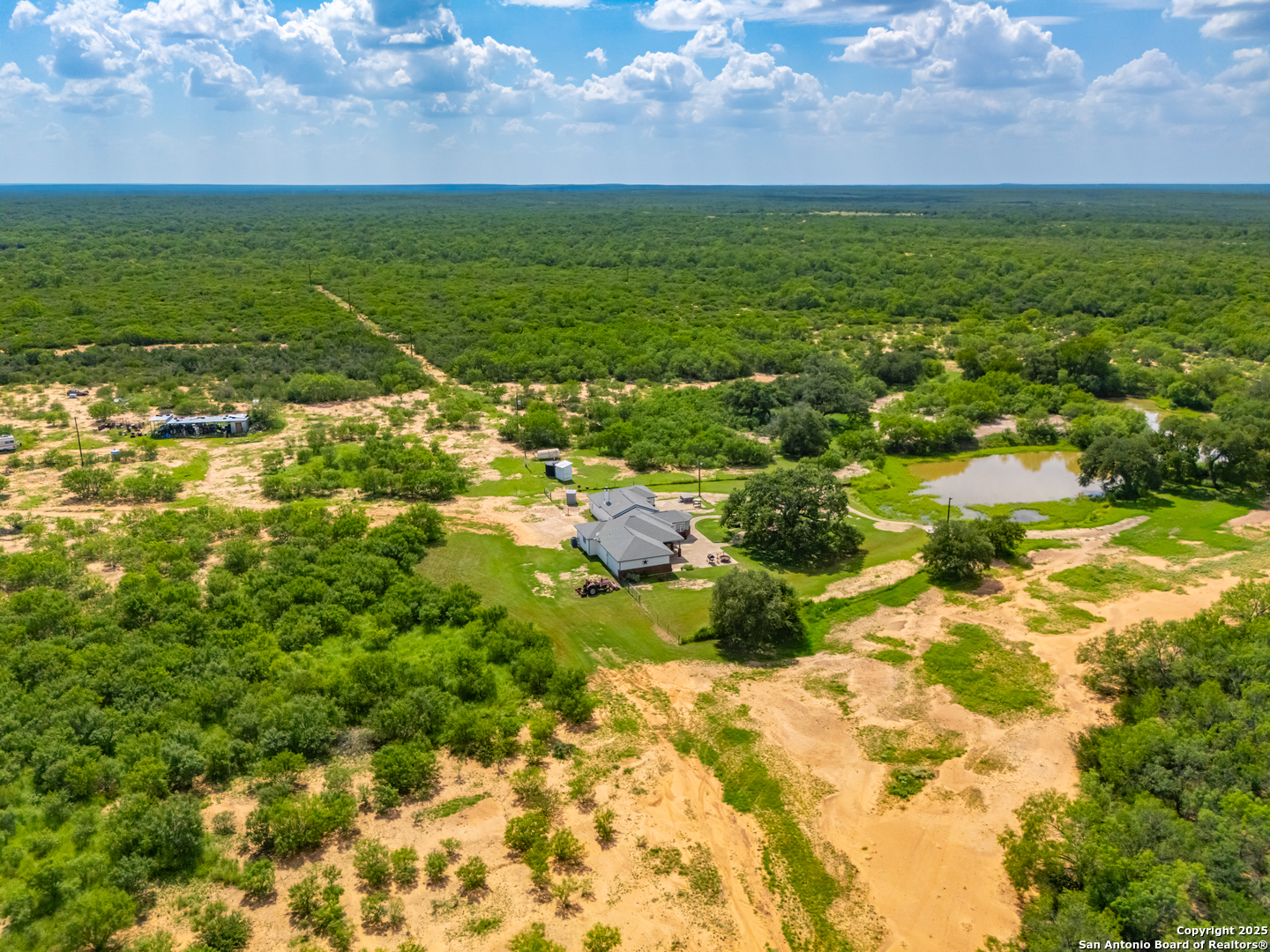 4614 County Road 5232 D'Hanis, TX 78850 - Photo 7 of 40 a view of a lake with a building in the background