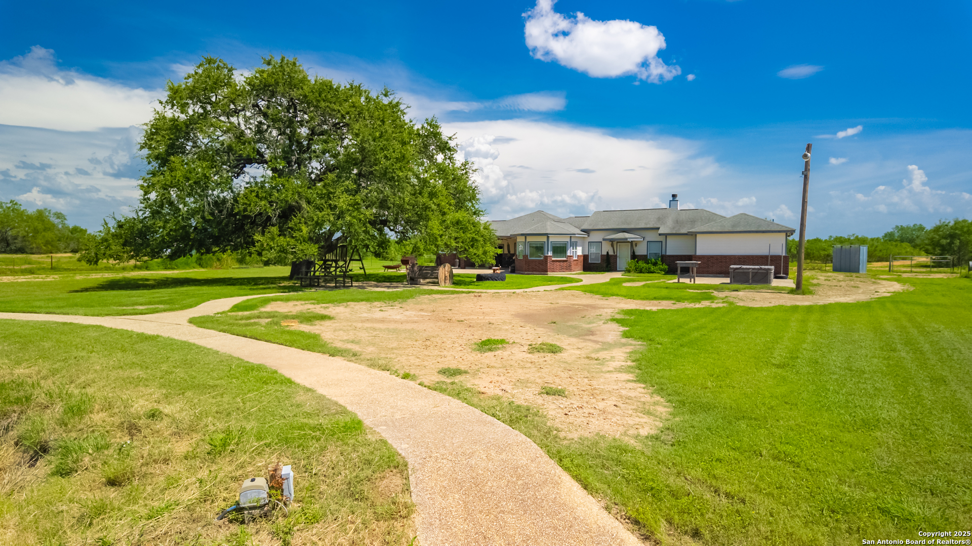 4614 County Road 5232 D'Hanis, TX 78850 - Photo 8 of 40 a view of a swimming pool with an outdoor space and seating area