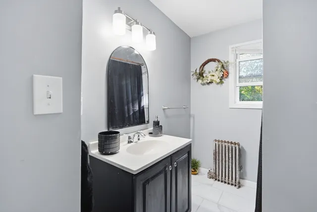 a bathroom with a sink and a mirror