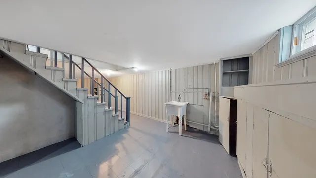a view of a livingroom with furniture and stairs