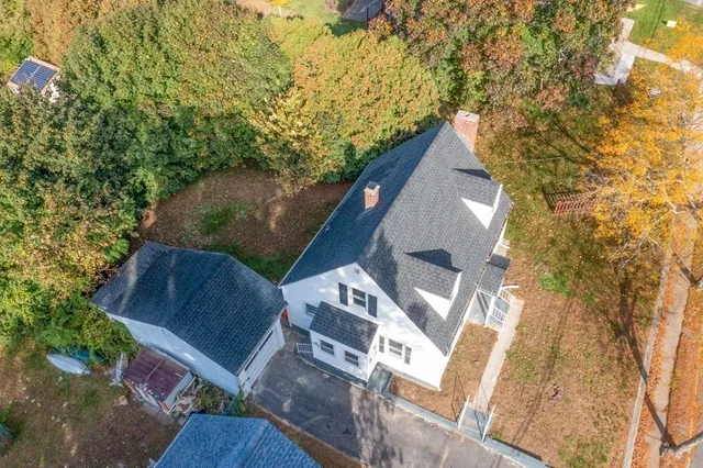 an aerial view of residential building with trees