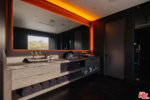 a bathroom with a granite countertop sink a toilet and a mirror