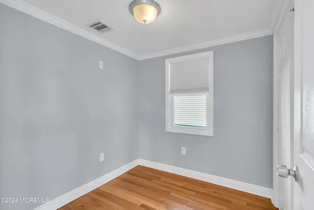 a bathroom with a granite countertop sink mirror vanity and toilet