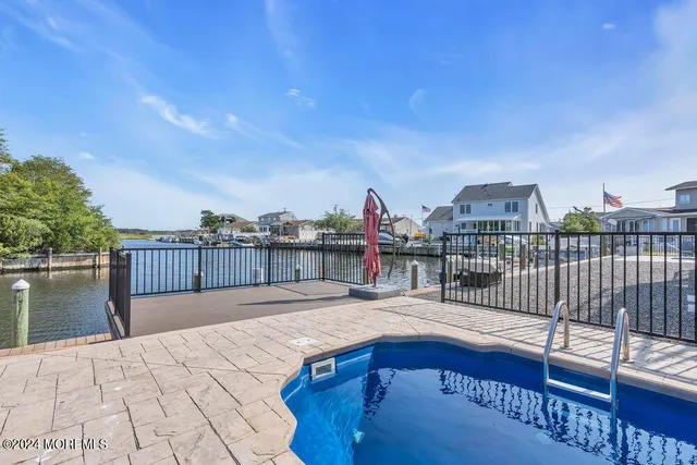 a view of a lake with boats and trees in the background