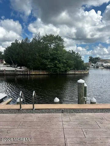 a living room with furniture a wooden floor and a floor to ceiling window