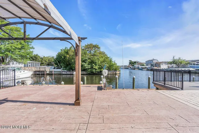 a living room with furniture wooden floor and a large window