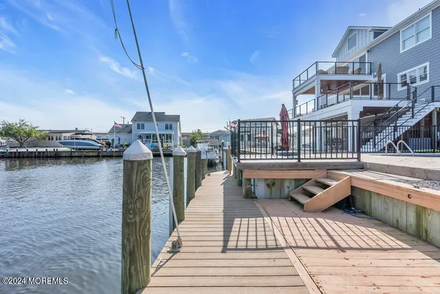 a living room with furniture wooden floor and a large window