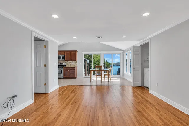 a view of a room with furniture and wooden floor