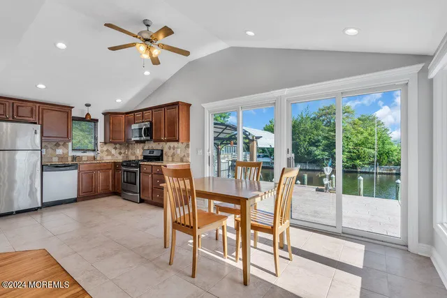 a kitchen with granite countertop stainless steel appliances a refrigerator and a sink