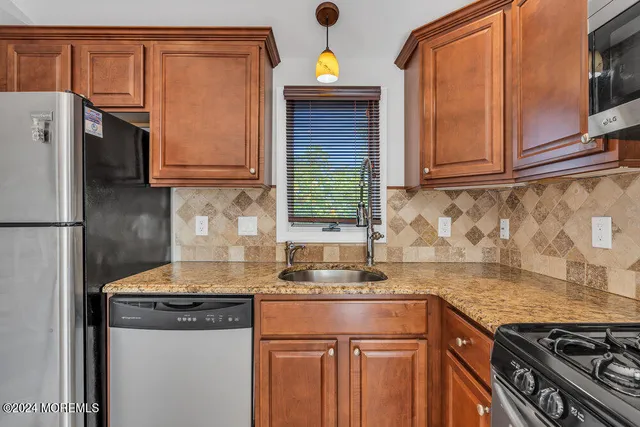 a dining hall with stainless steel appliances granite countertop a granite counter tops and a view of living room
