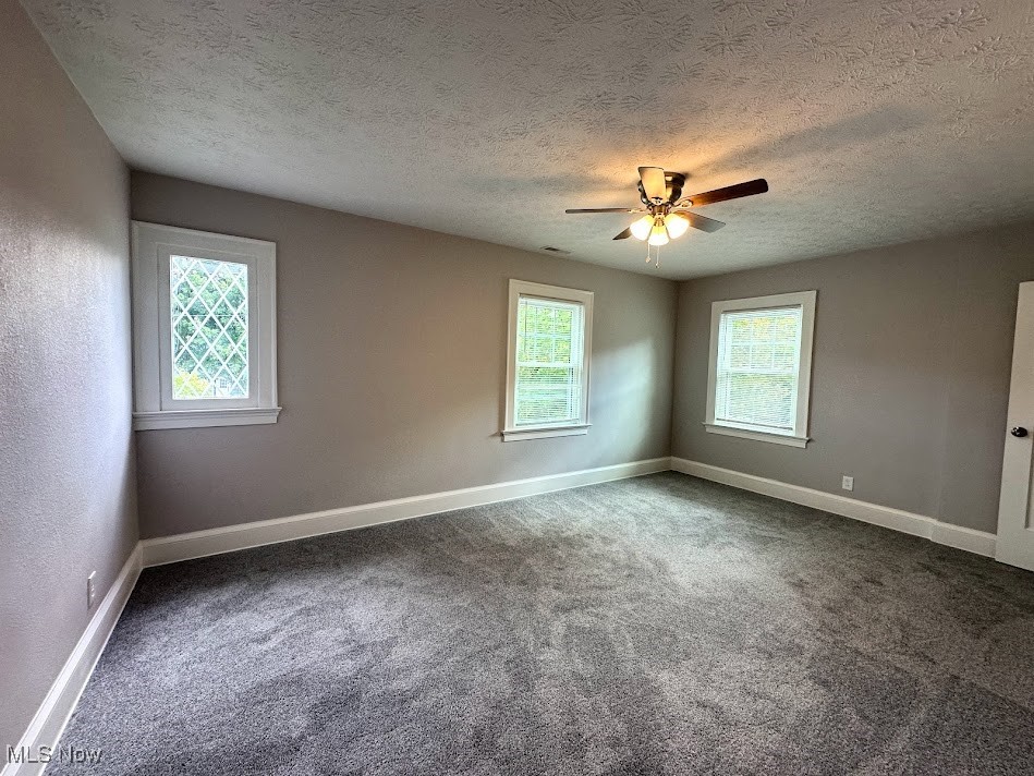 3190 Warrington Road Cleveland, OH 44120 - Photo 16 of 21 Unfurnished room featuring carpet floors, a textured ceiling, and ceiling fan