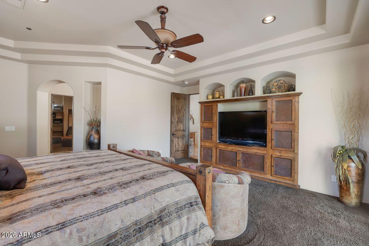 18507 East Picacho Road Rio Verde, AZ 85263 - Photo 17 of 33 a bedroom with a bed and a flat screen tv