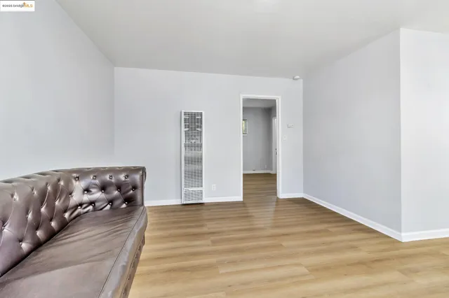 a view of an empty room and wooden floor
