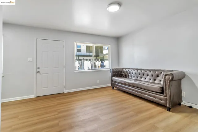 a view of a room with wooden floor and window