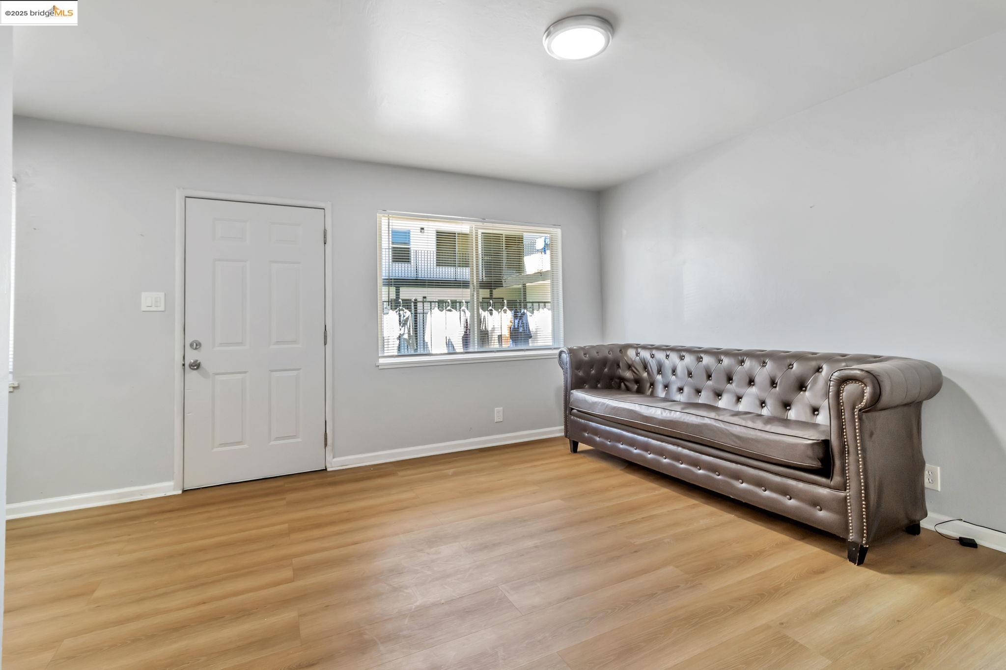 1626 Dwight Way Berkeley, CA 94703 - Photo 14 of 46 a view of a room with wooden floor and window