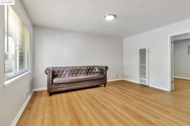 a view of a bedroom with furniture and wooden floor