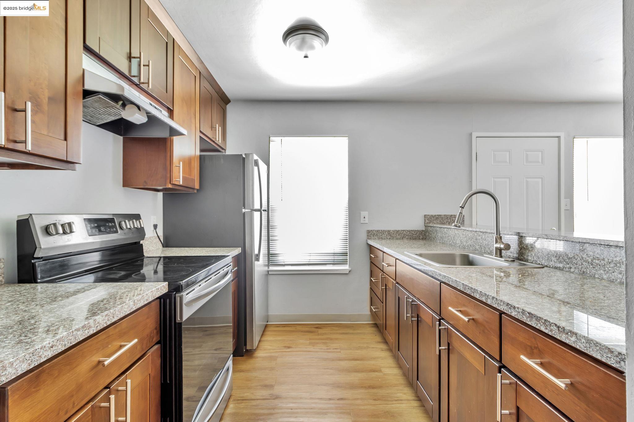 1626 Dwight Way Berkeley, CA 94703 - Photo 24 of 46 a kitchen with stainless steel appliances granite countertop a sink and a stove