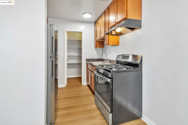 a kitchen with stainless steel appliances granite countertop a stove and a refrigerator