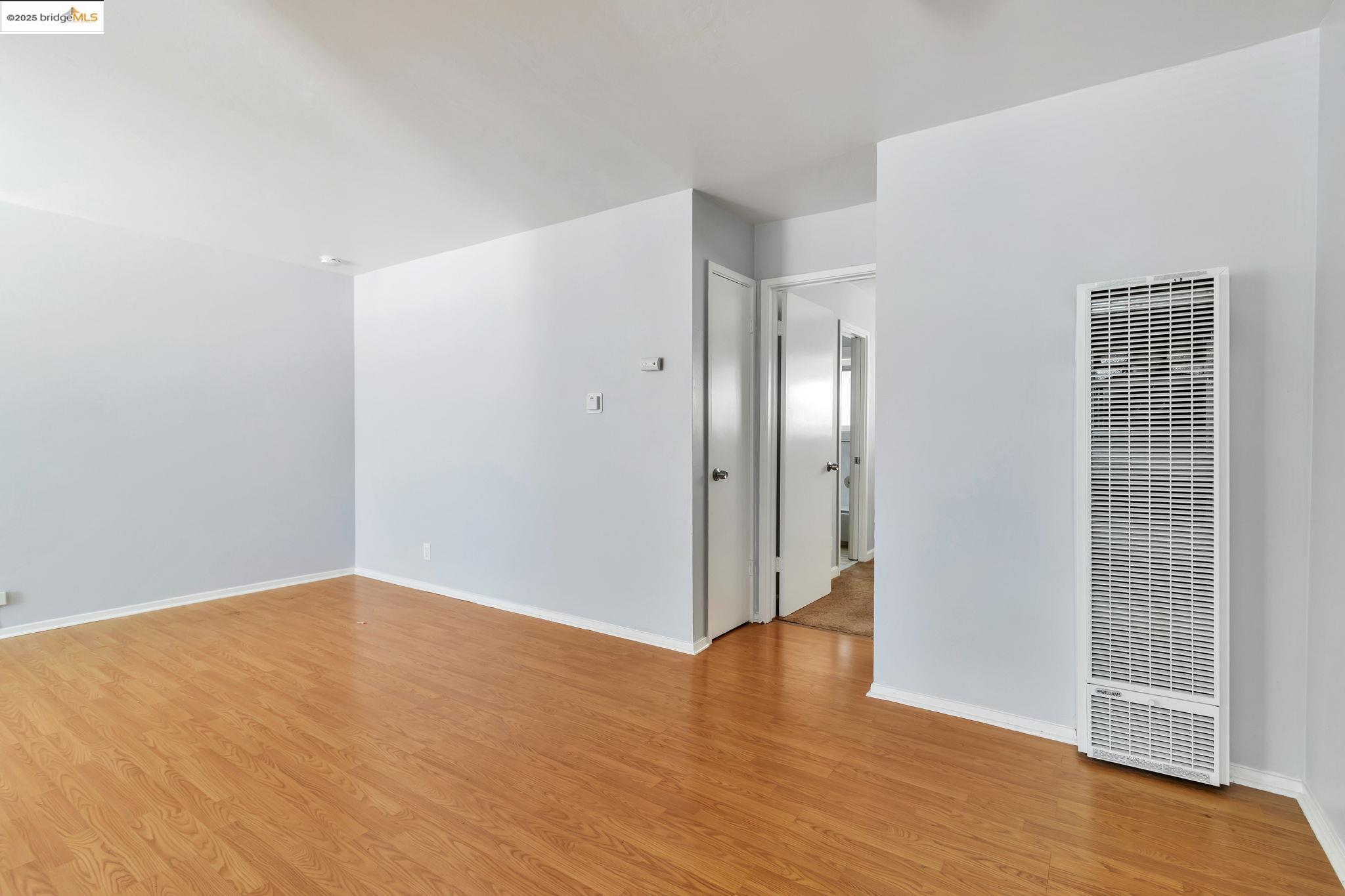 1626 Dwight Way Berkeley, CA 94703 - Photo 37 of 46 a view of an empty room with wooden floor and a bathroom