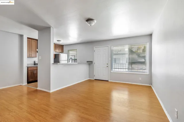 a view of livingroom with kitchen and window