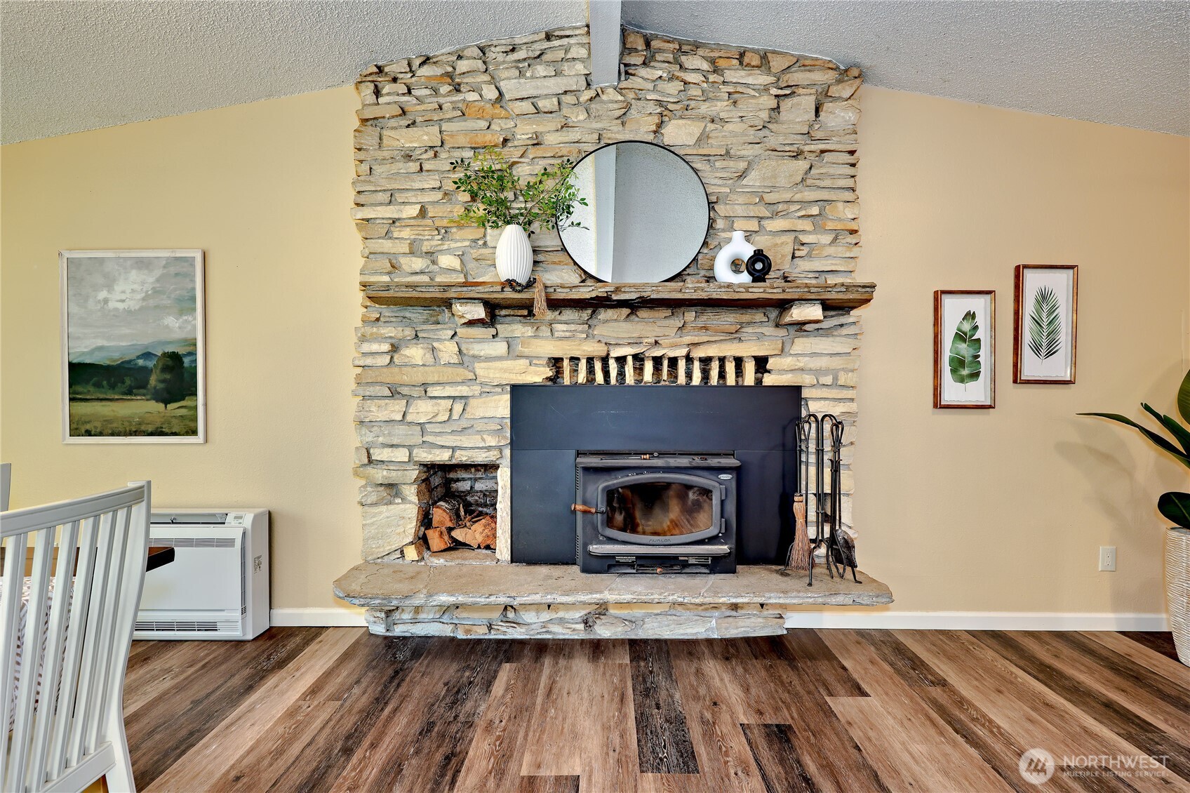 12161 South Keyport Road Northeast Poulsbo, WA 98370 - Photo 13 of 40 a living room with a fireplace and a wooden floor