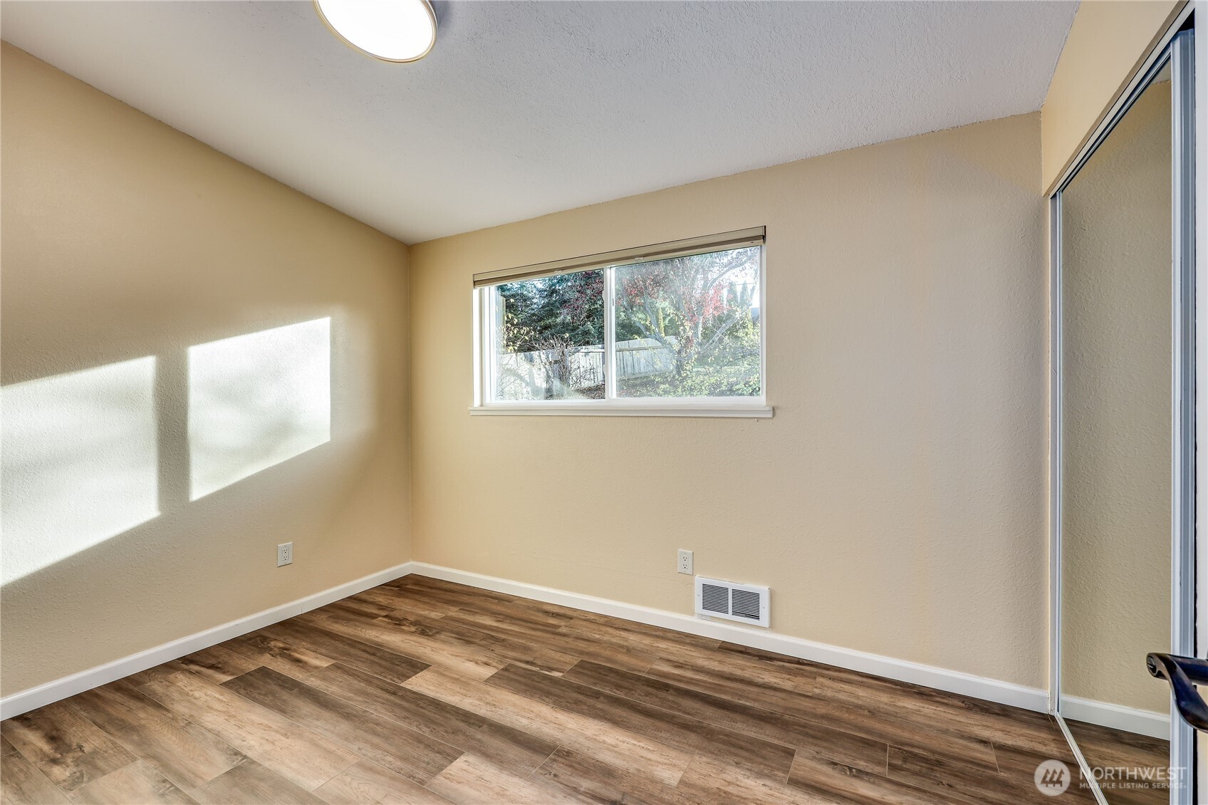 12161 South Keyport Road Northeast Poulsbo, WA 98370 - Photo 20 of 40 a view of a room with wooden floor and window