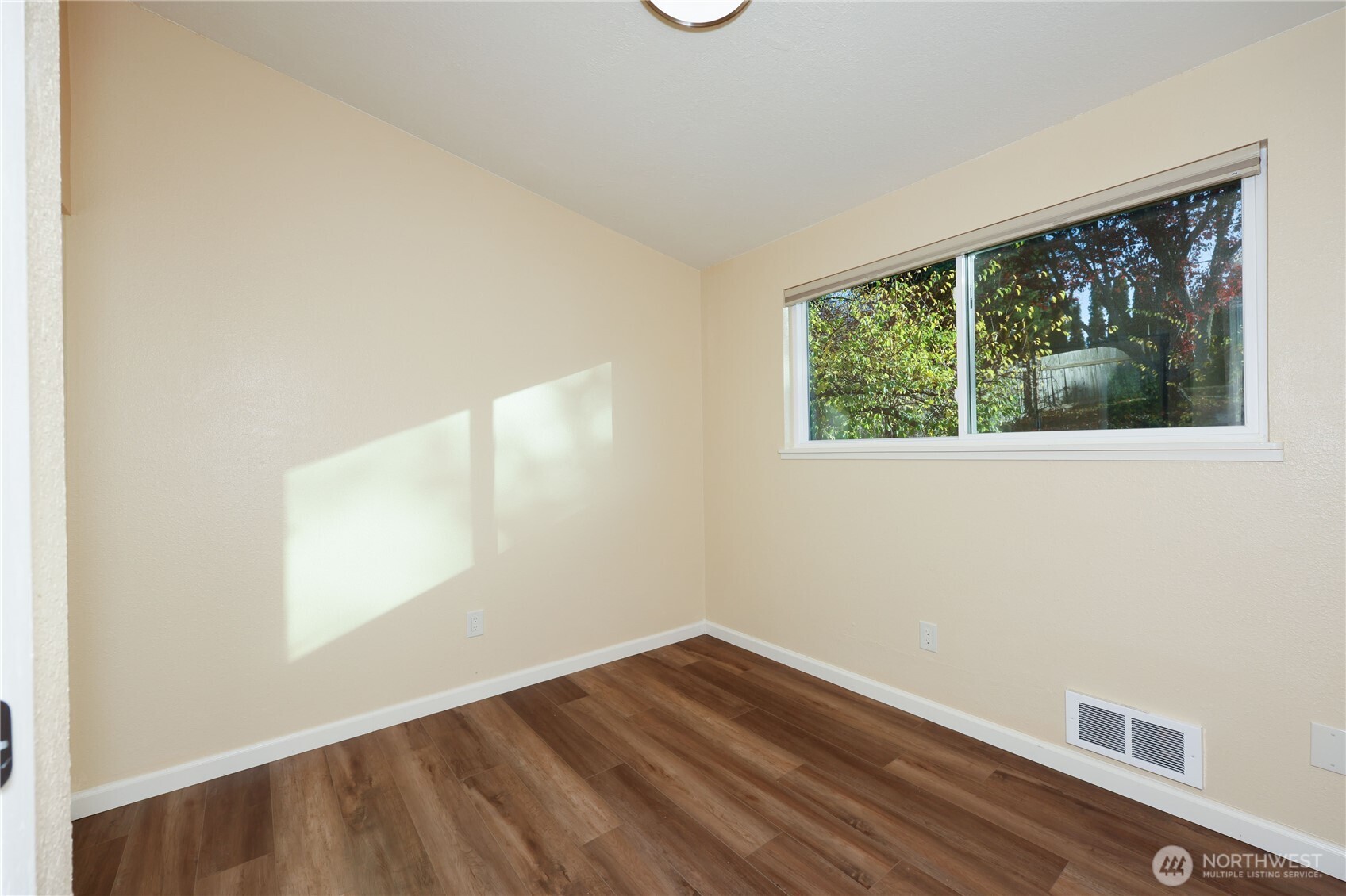 12161 South Keyport Road Northeast Poulsbo, WA 98370 - Photo 23 of 40 an empty room with wooden floor and windows