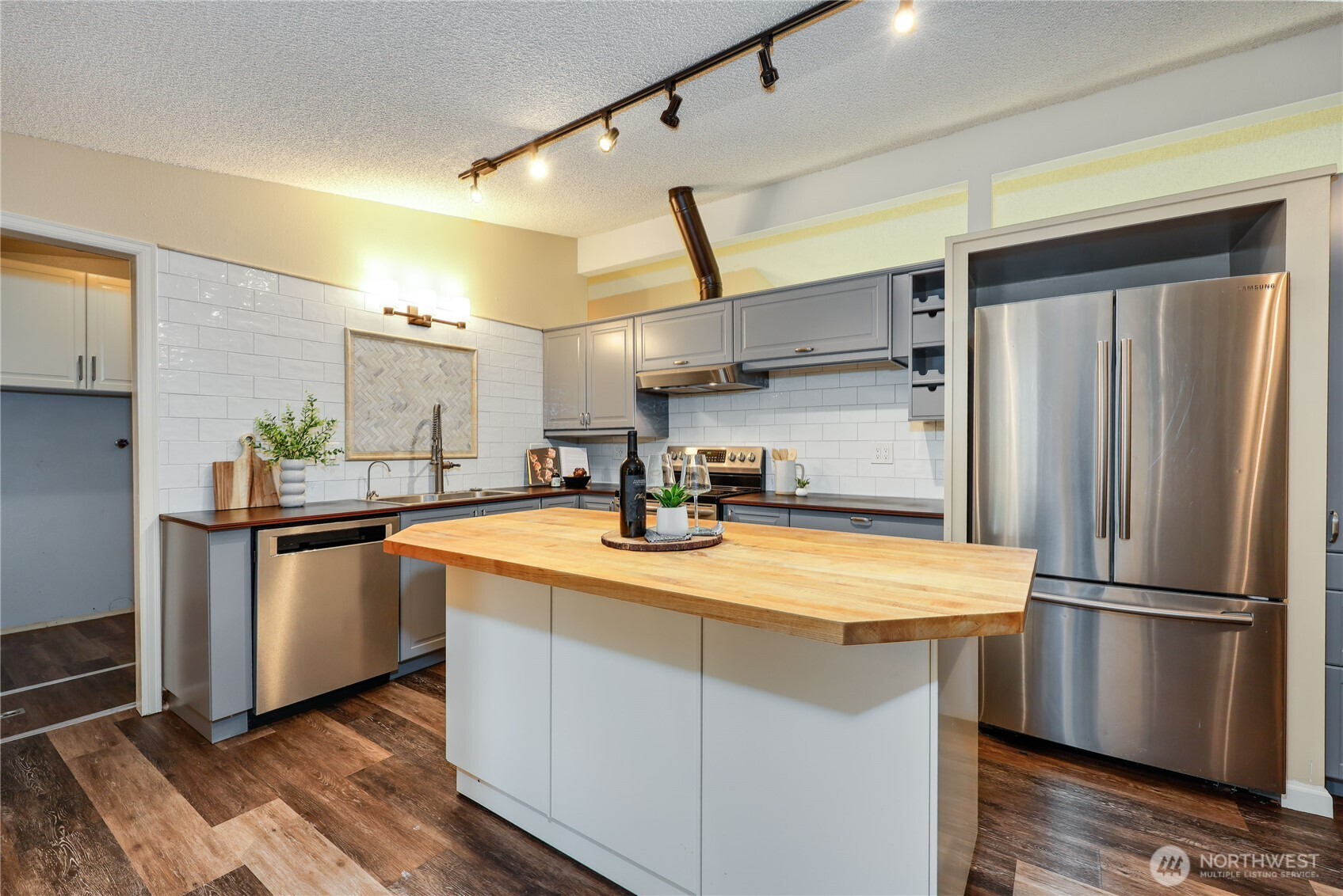 12161 South Keyport Road Northeast Poulsbo, WA 98370 - Photo 10 of 40 a kitchen with stainless steel appliances a refrigerator and a stove