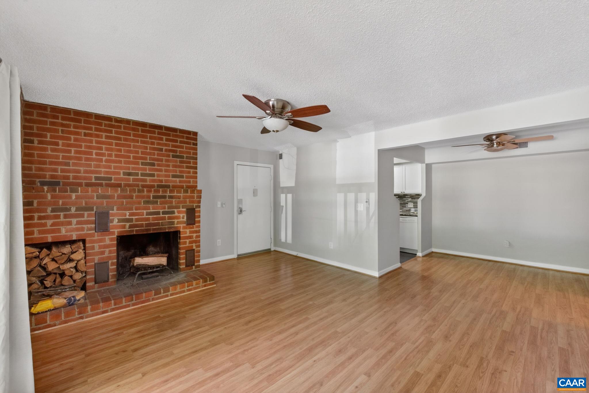 103 Turtle Creek Road, Unit 8 Charlottesville, VA 22901 - Photo 6 of 37 a living room with wooden floor and a fireplace