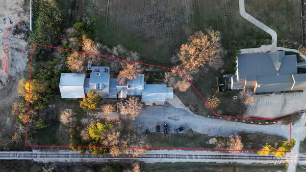 an aerial view of a house with a yard basket ball court and outdoor seating