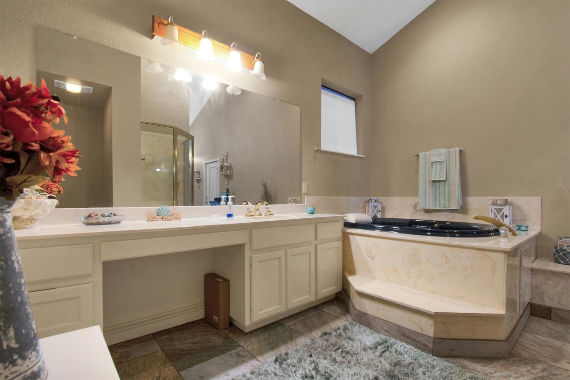 416 Depot Street Elgin, TX 78621 - Photo 13 of 21 Full bathroom featuring a shower stall, vanity, and a garden tub