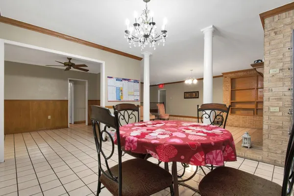 a dining room with furniture and chandelier