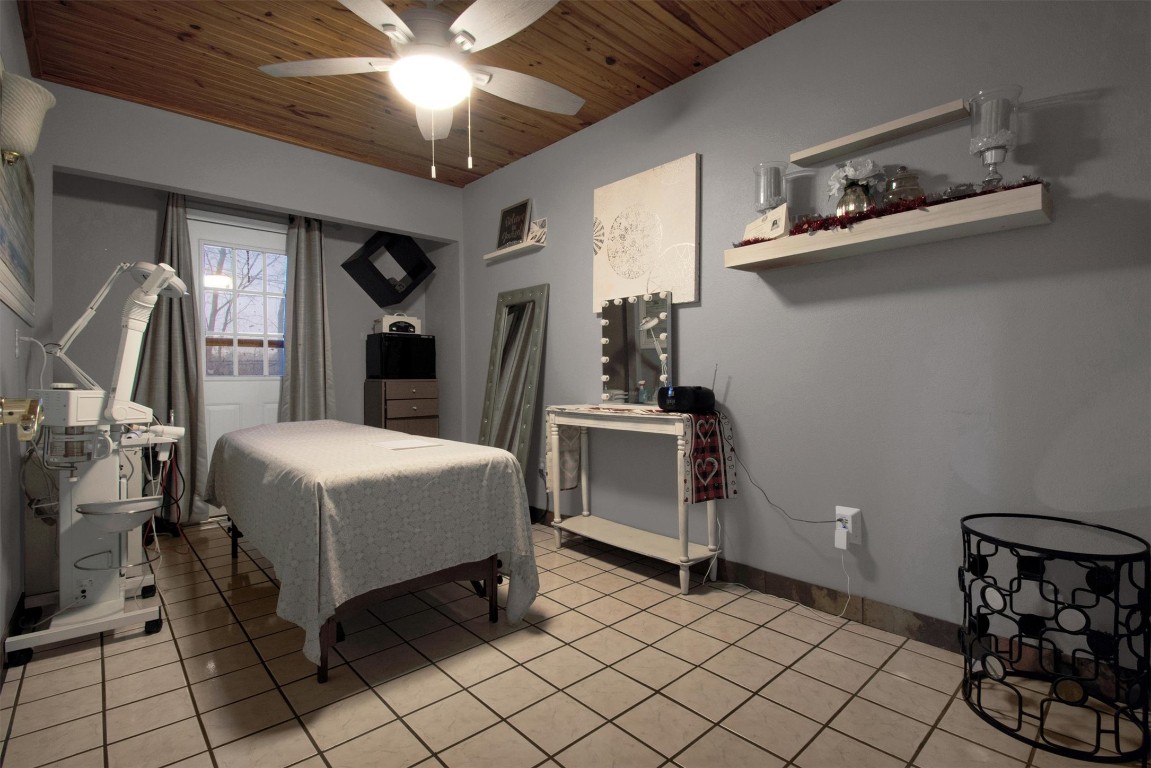 416 Depot Street Elgin, TX 78621 - Photo 16 of 21 Bedroom featuring wood ceiling, ceiling fan, and light tile patterned floors