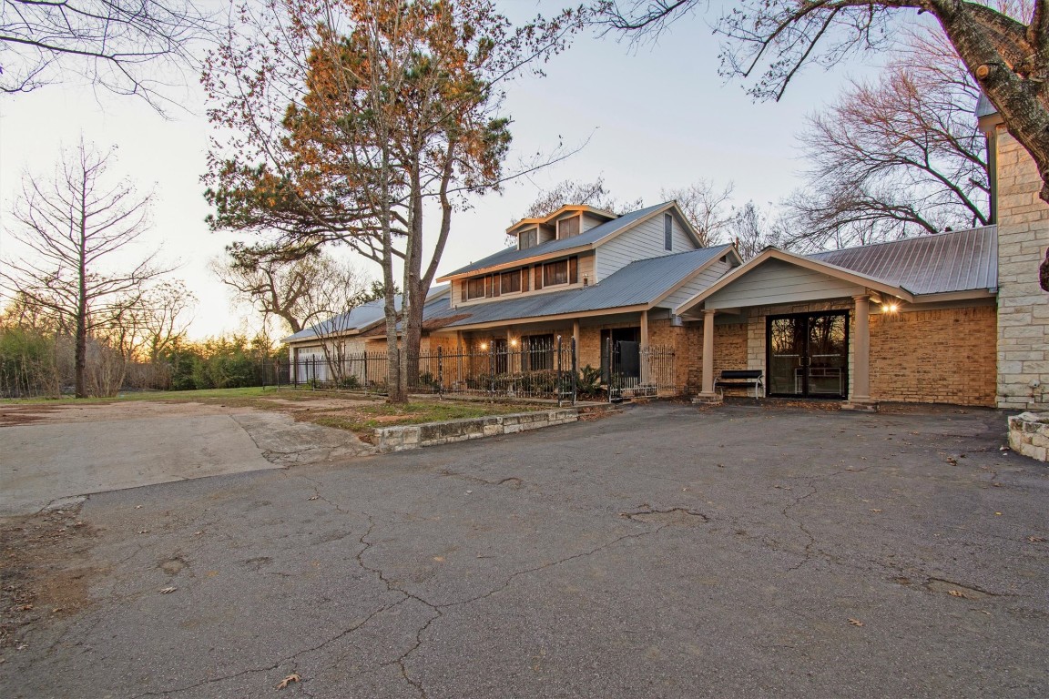 416 Depot Street Elgin, TX 78621 - Photo 5 of 21 View of front facade featuring driveway, a metal roof, and a porch