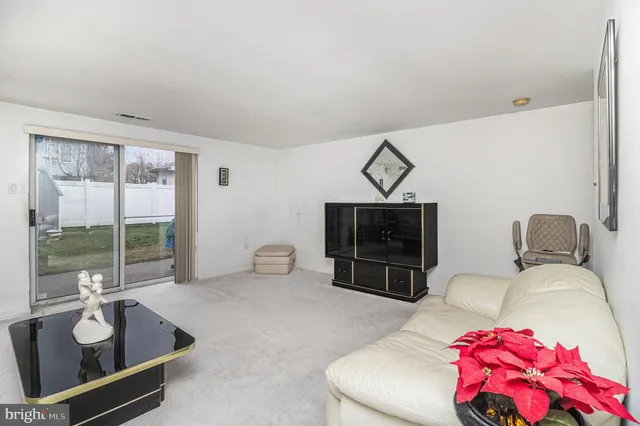 a view of a hallway with bathroom and a shower