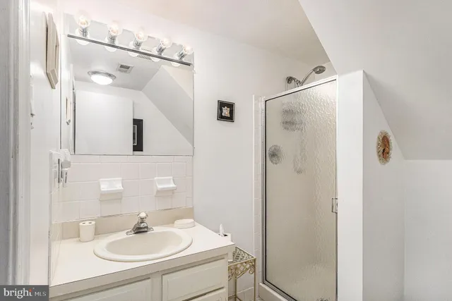 a spacious bedroom with a bed and a chandelier