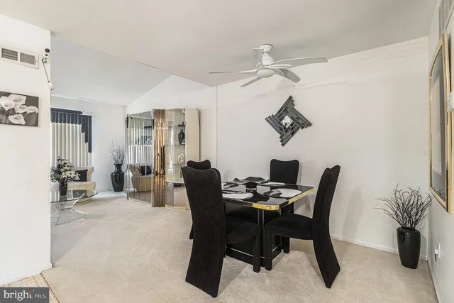 a kitchen with stainless steel appliances granite countertop a refrigerator sink and white cabinets