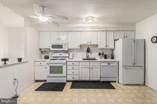 a kitchen with cabinets and window