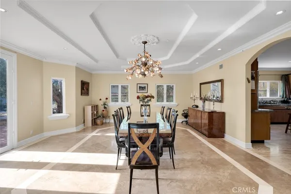 a view of a dining room with furniture and chandelier
