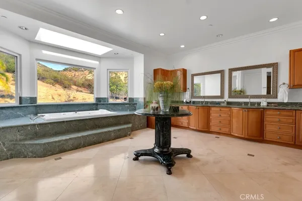 a view of a bathroom with a tub and large window